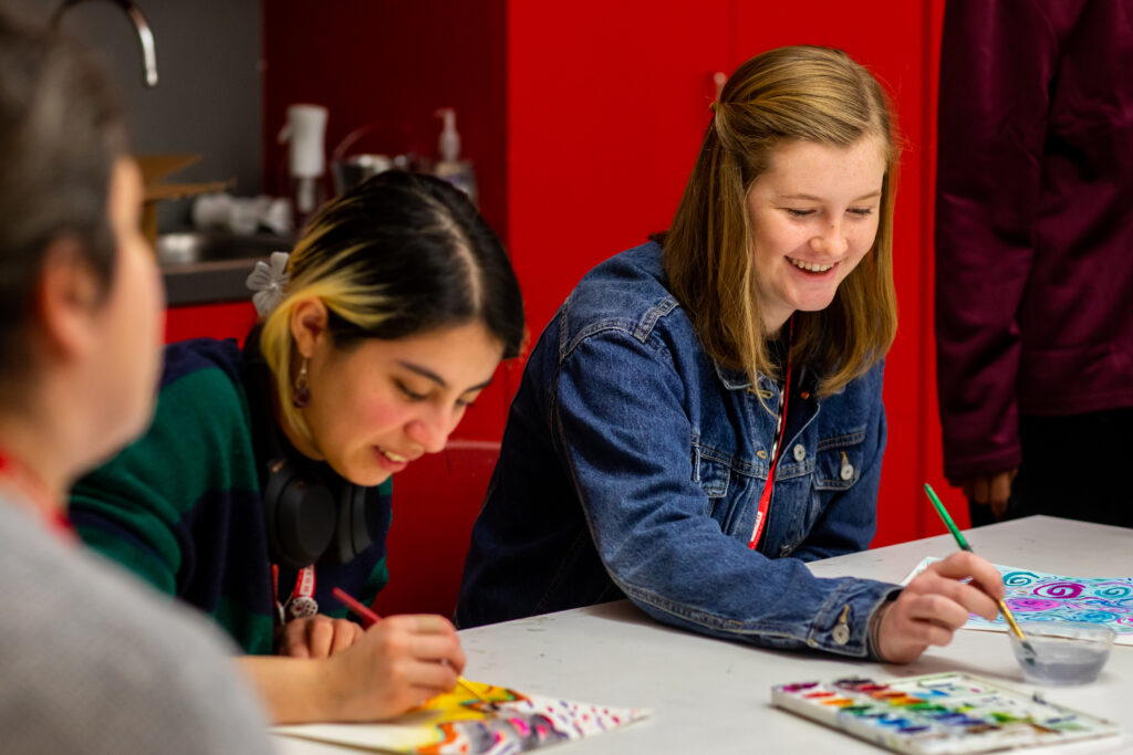 Two teens use paint with watercolors