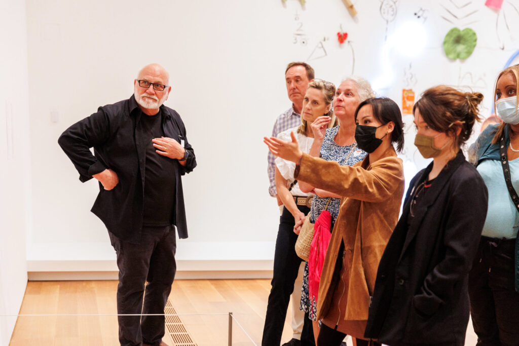 docent tour, groups, adults A man in all black talks to a group of smartly dressed adults inside the modern and contemporary galleries at the High Museum