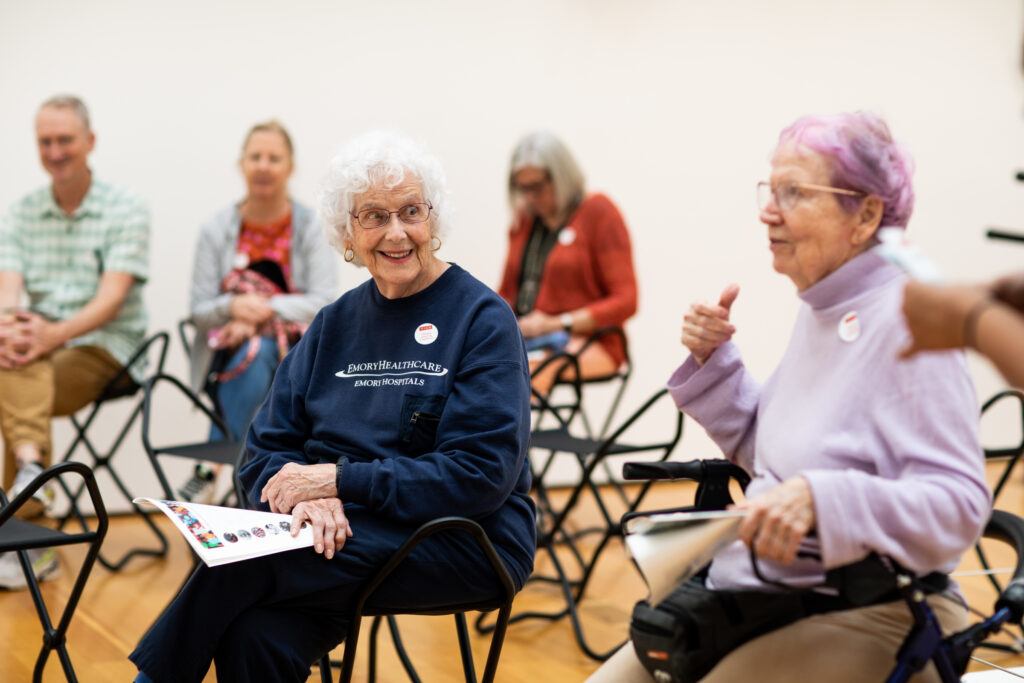 Senior adults talking while sitting on stools