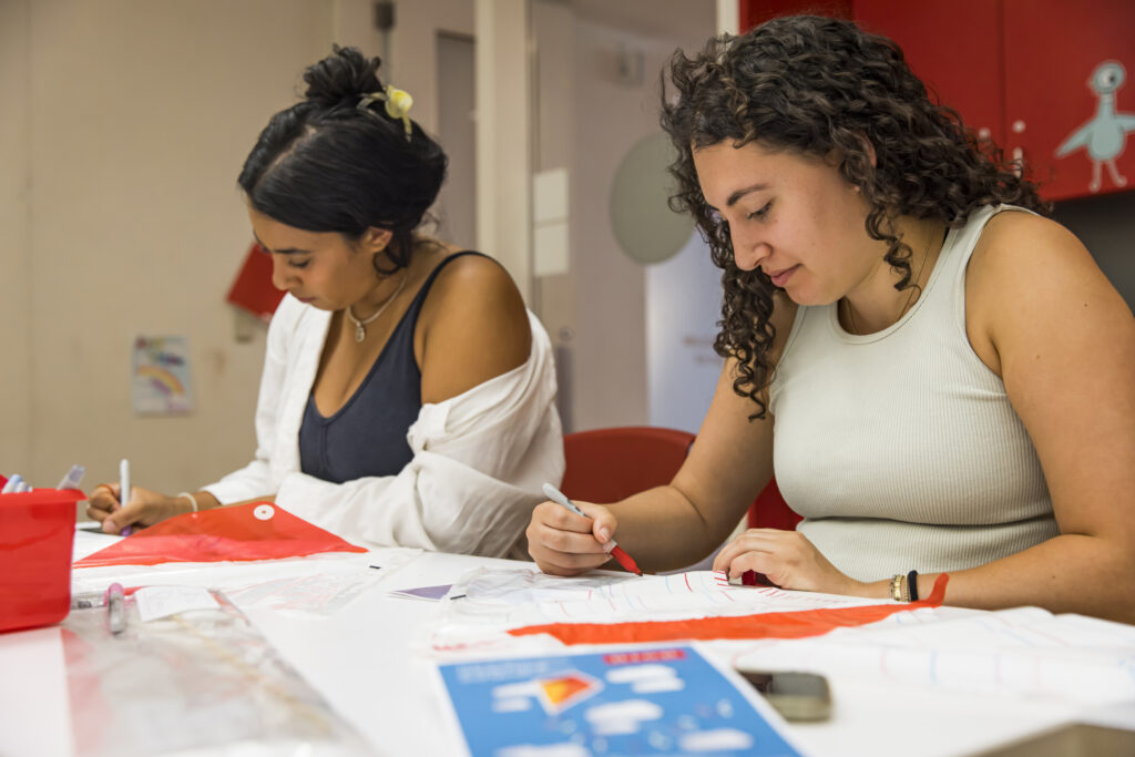 Two individuals drawing intently.