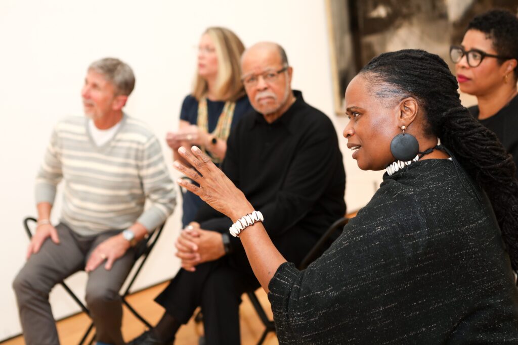 group of older adults discussing a work of art.
