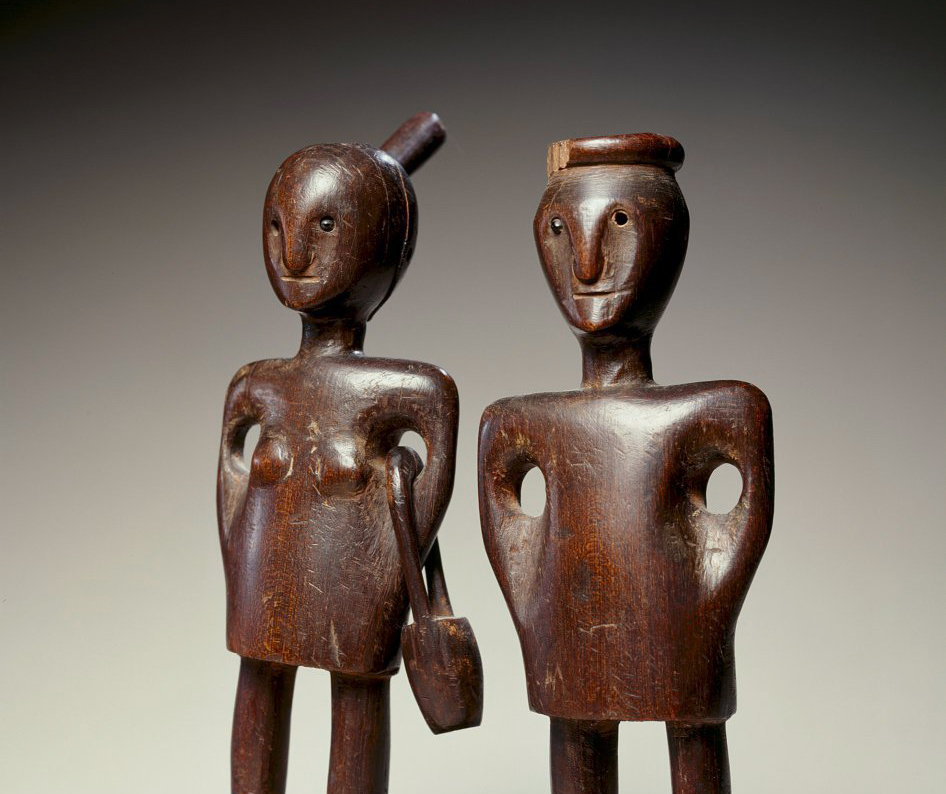 pair of male and female wooden figures.
